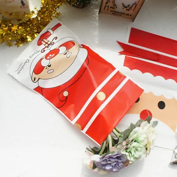 23.5*14.5 cm 50tk Punane Jõulud Jõuluvana Põder Lumememm Disain Kott jõulupidu Kingitus Plastikust Pakendi Kotid Lindiga